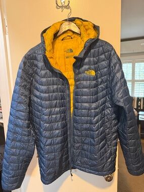The North Face Men's Dark Blue Puffer Jacket with Yellow Lining with hood